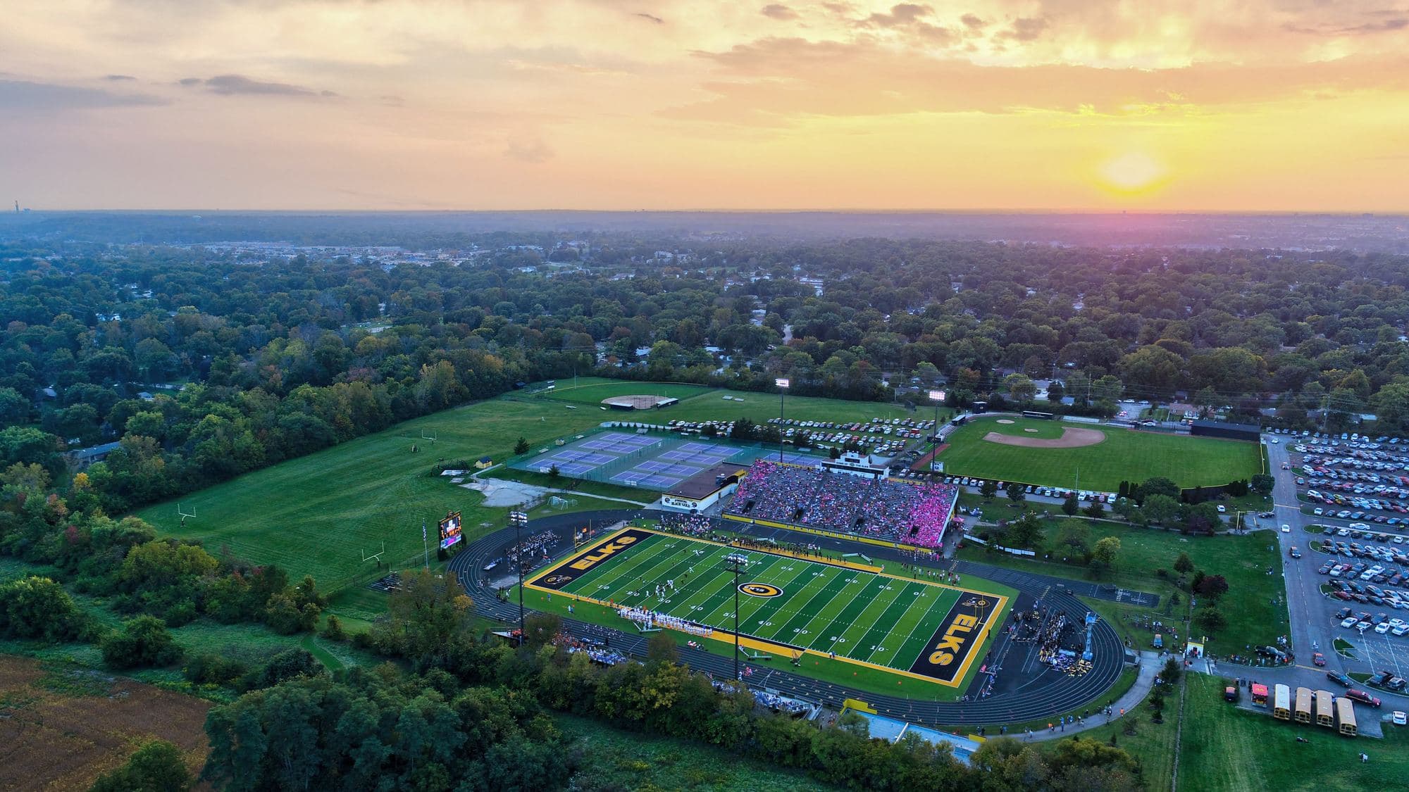 A stadium at dusk lit by a Major Display video board
